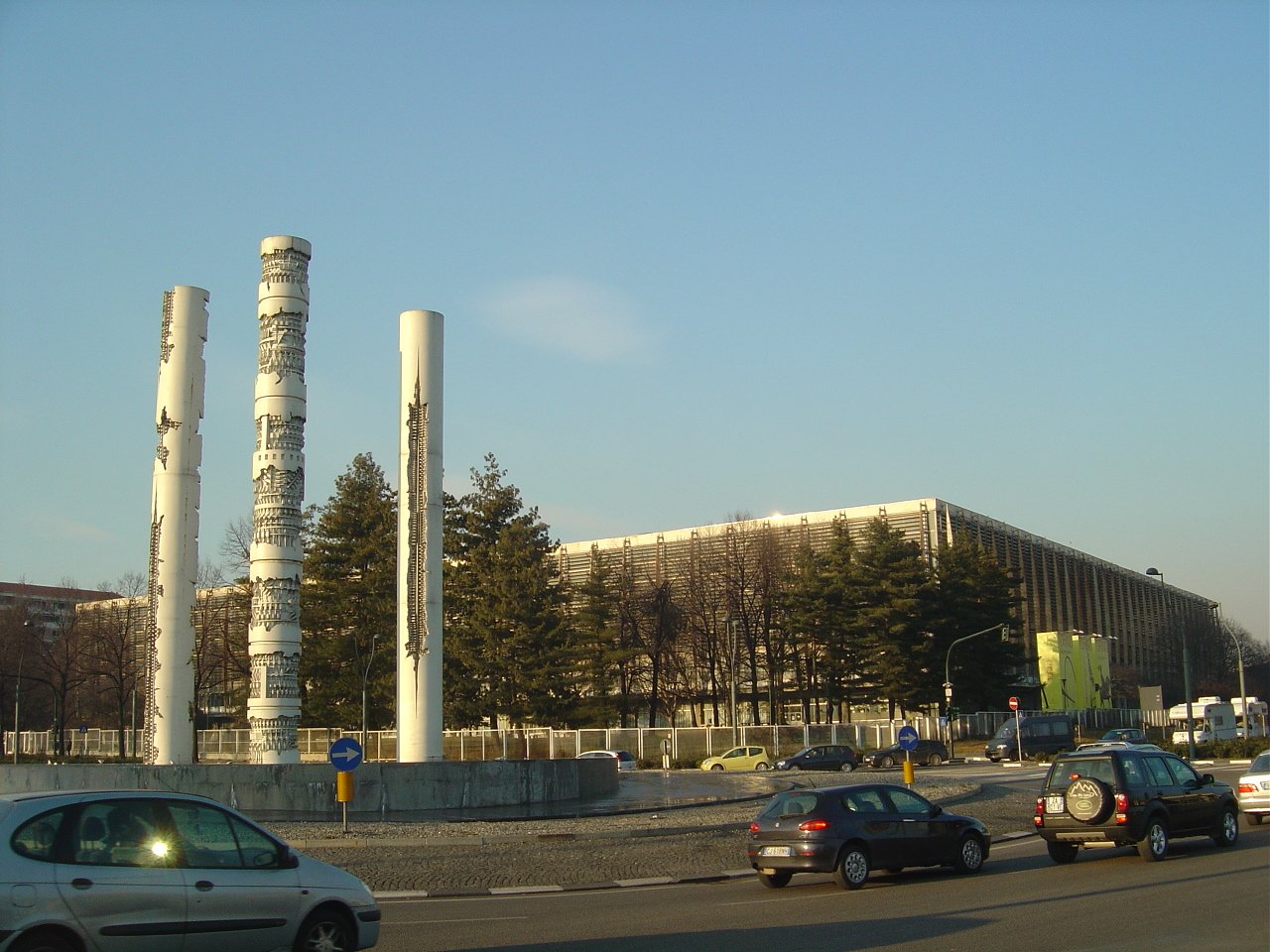 Exterior view of the Palazzo del Lavoro in Turin seen from Rotonda Maroncelli, with its quadrangular concrete pavilion and modular steel roof