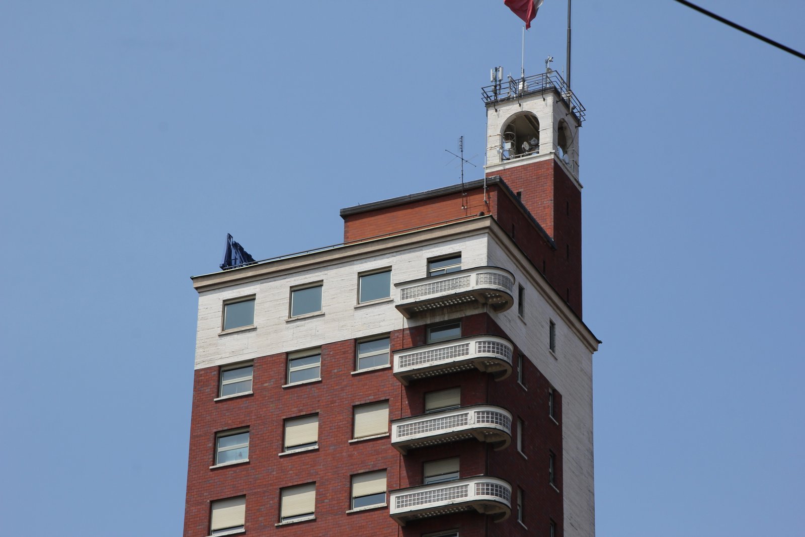 Torre Littoria in Turin seen from Piazza Castello, with its slender vertical shaft rising over the surrounding rooflines